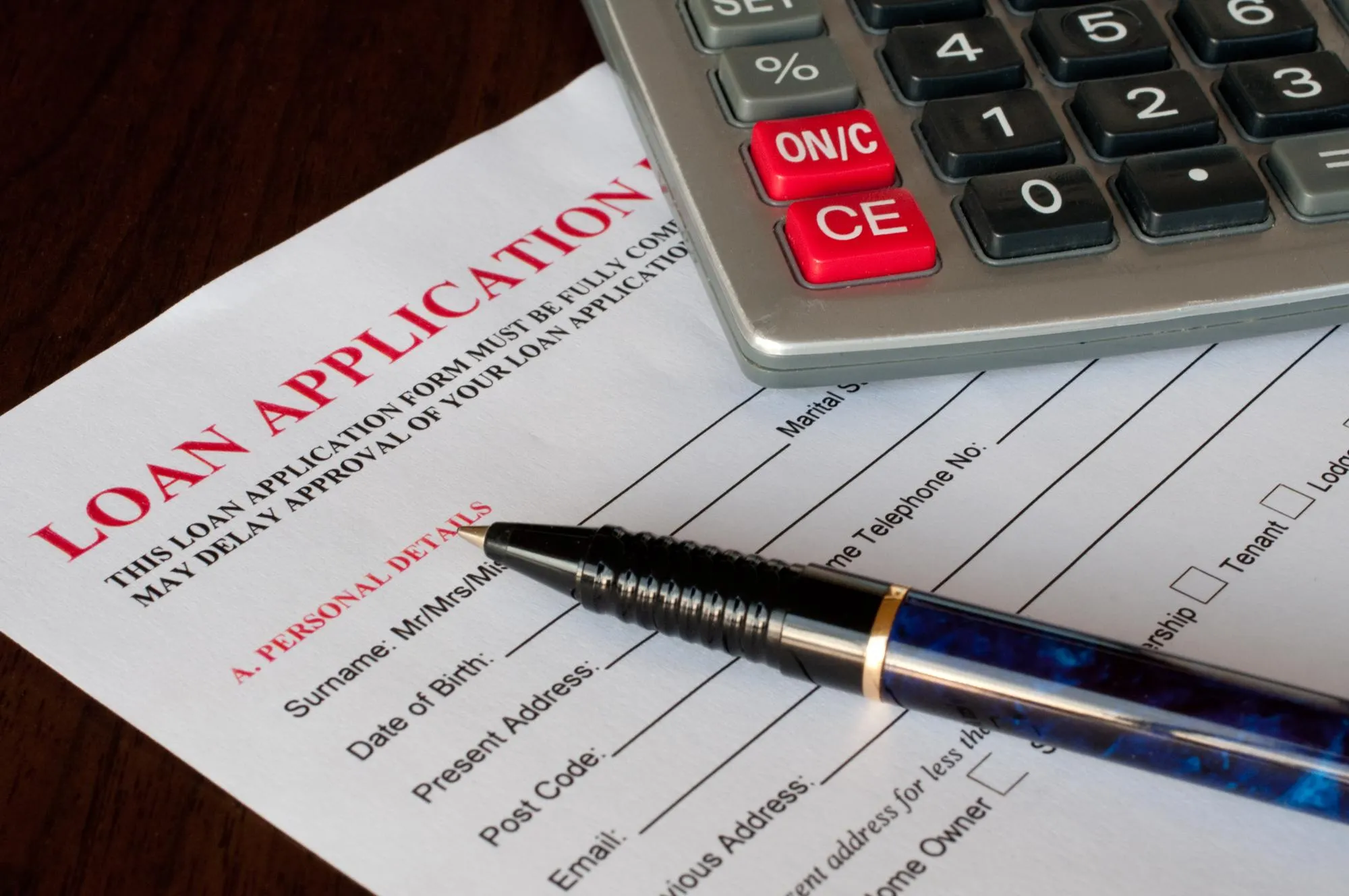 Credit underwriter reviewing loan application and repayment ability.