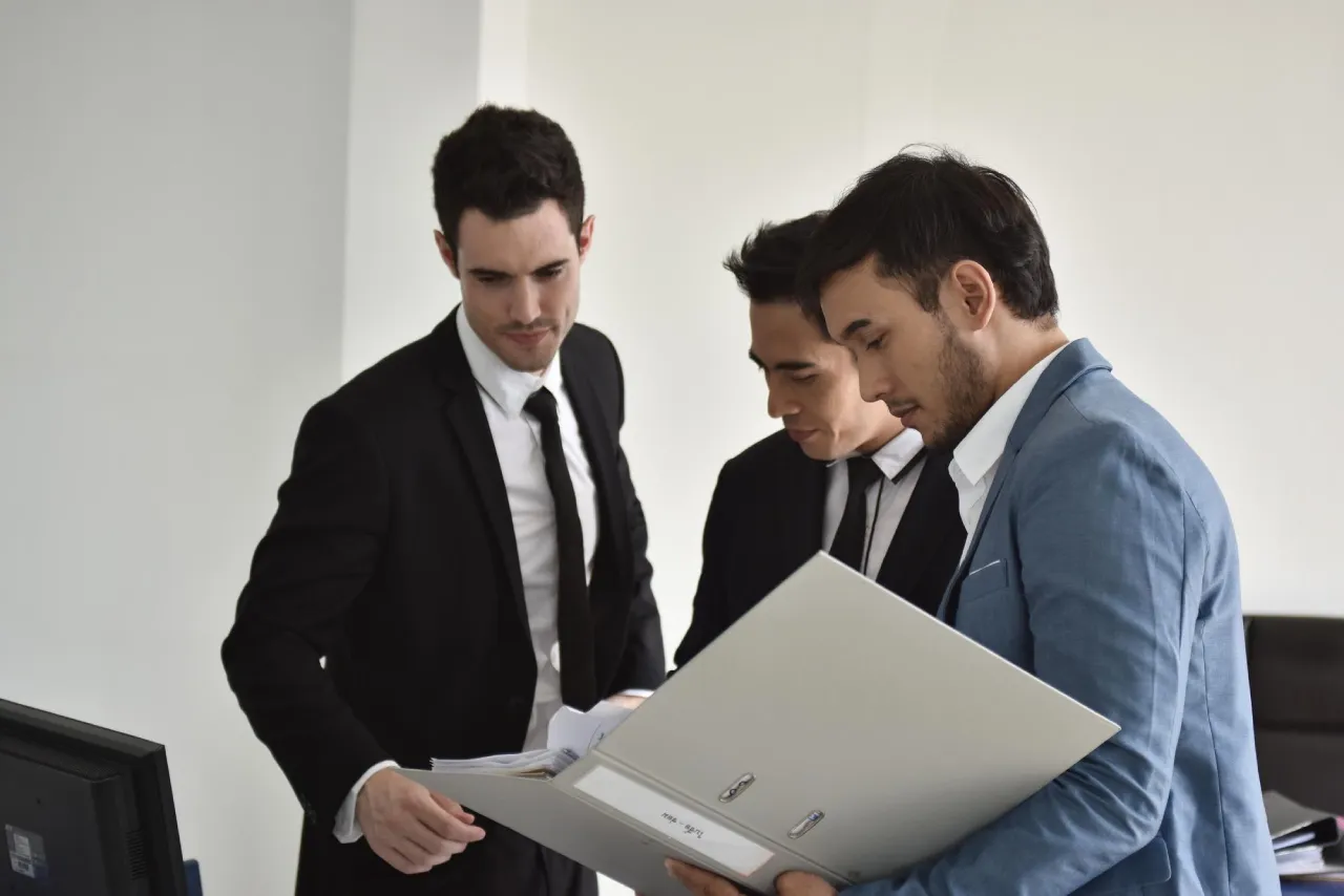 Team reviewing documents to overcome audit hiring challenges.